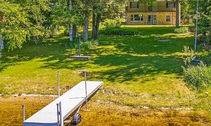 Johannesburg Haus | Lakefront home with large yard, dock, gas grill, WIFI near golf & ATV trails!