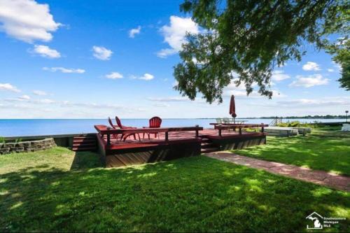 Luna Pier Haus | Restored historic log cabin & deck on Lake Erie