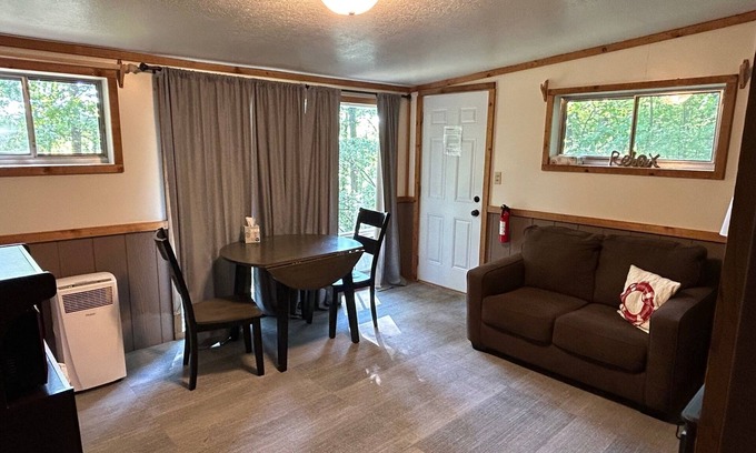 Palmyra Hütte | Rustic cabins in secluded campground with lake access and woods to wander in.