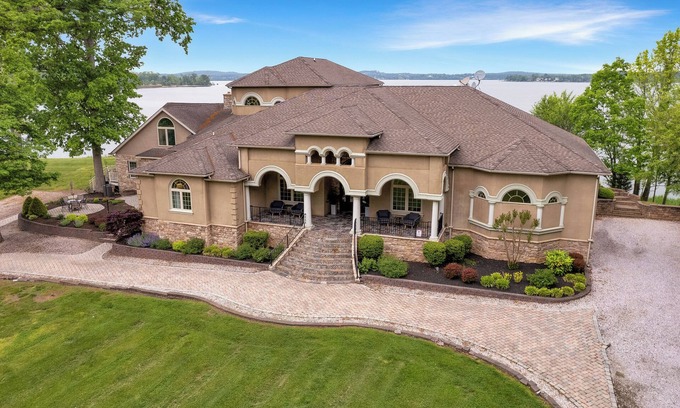 Earlville Villa | Stunning waterfront villa with indoor pool and kids swing set and play area.