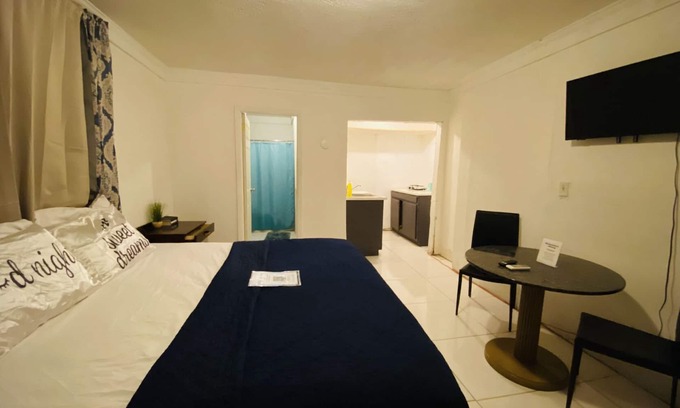 Nassau Haus | The Dollie Mae: Comfortable King Bed Suite