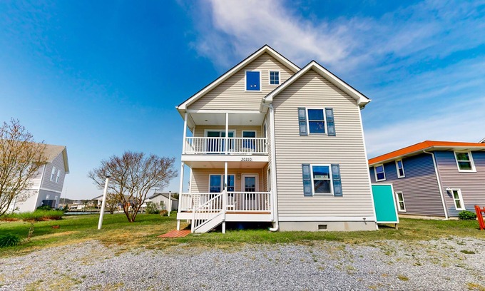 Cedar Neck Haus | Town of Ocean View canal-front home with dock, kayaks, balconies, grill, & AC