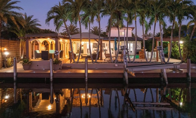 Sunset Haus | Villa Les Palmieres, a lush waterfront residence with pool and dock