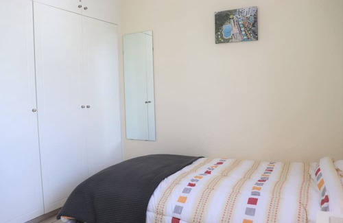 Peyia Town Haus | Direct access to the pool from the garden. A sandy beach is a few minutes away.