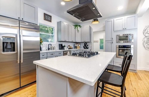 Mickleton Haus | Embrace the charm of our creekside haven featuring 4BR 3BA yoga and BBQ deck.