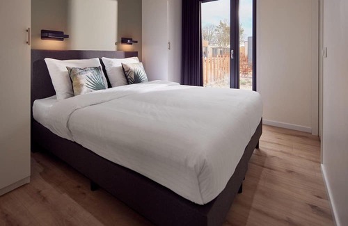 Lattrop Haus | The Amalia is a four-person holiday home and has an attractive homely living room with an open kitchen, two bedrooms and a spacious outdoor area.