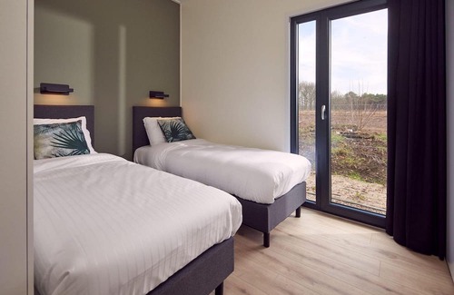 Lattrop Haus | The Amalia is a four-person holiday home and has an attractive homely living room with an open kitchen, two bedrooms and a spacious outdoor area.