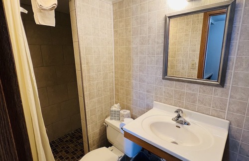 Onalaska Haus | Overlooking Lake Onalaska -- Queen bed + bathroom in nostalgic motel