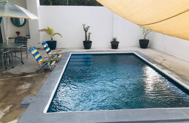 House with pool one block from the beach!