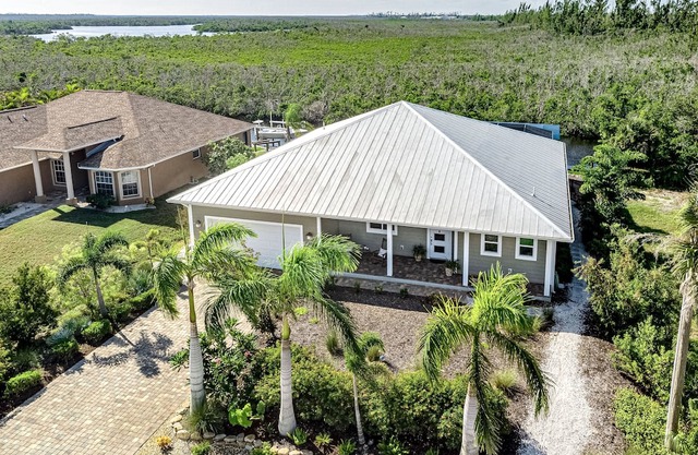 Canal-side charmer with enclosed pool, waterside deck, open layout, & W/D