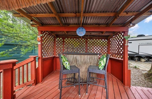 THIS IS AN AWESOME 36' RENTAL CAMPER WITH AMAZING LONG DECK, PLUS A SECOND STEP-DOWN DECK TO YOUR OWN PRIVATE HIDEAWAY TIKI BAR! A BEAUTIFUL HUGE LIVE OAK COVERS THE ENTIRE LOT SO IT'S ALWAYS SHADED, AND THIS EVEN COMES WITH A TABLE & CHAIRS FOR OUT